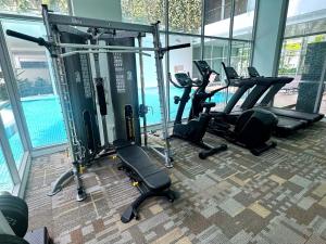a gym with treadmills and ellipticals in a building at Oxley Thanksgiving Residence in Singapore