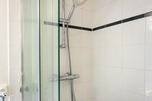 a shower with a glass door in a bathroom at Studio avec balcon Centre Ville in Montreuil