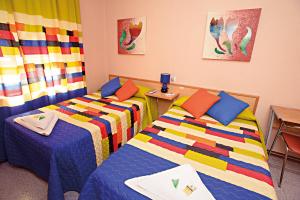 Postel nebo postele na pokoji v ubytování Hostal Carrizo