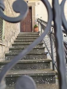a set of stairs leading to a wooden door at DaLu' tourist accommodation in Vallerano