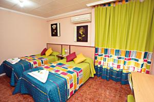 Postel nebo postele na pokoji v ubytování Hostal Carrizo