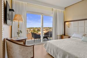 a bedroom with a bed and a view of a balcony at Boutique Hotel Oasi in Pula +60 photos