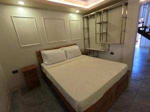 a small bedroom with a bed in a room at Annie's Lodge Agoo in Agoo +5 photos