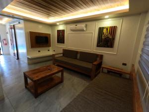 a living room with a couch and a table at Annie's Lodge Agoo in Agoo