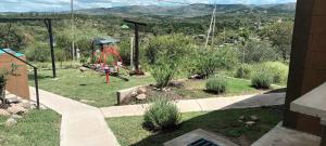a backyard with a playground with a swing at Cabañas El Molle in Cavalango