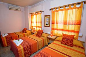 Postel nebo postele na pokoji v ubytování Hostal Carrizo