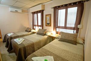 Postel nebo postele na pokoji v ubytování Hostal Carrizo