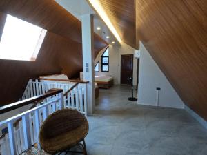 an attic room with a staircase and a chair at Annie's Lodge Agoo in Agoo