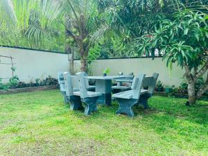 a picnic table and chairs in a garden at Dream villa in Imaduwa