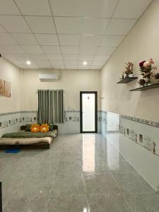 a room with two beds and a door with flowers on it at Thùy Vinh Homestay in Phú Quốc +16 photos