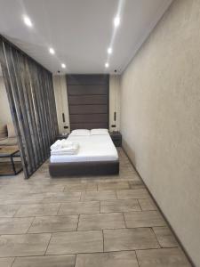 a bedroom with a bed and a tiled floor at Rayana's in Vanadzor