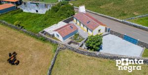 an aerial view of a house with a pool at Recanto das 5 by PontaNegraAzores in Cinco Ribeiras