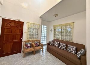 a living room with a couch and a door at Nielo's Apartment Door 4 in Dapitan +1 photo