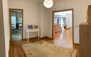 a living room with a table and a mirror at El Balcón de la Encina in Ponferrada