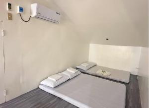a hospital room with a bed and a light at Nielo's Apartment Door 4 in Dapitan