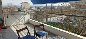 two chairs sitting on a balcony with a view at Διαμέρισμα 110 Μ στον Λαγκαδά in Lagadas