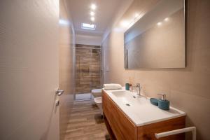 a bathroom with a sink and a toilet at La Dimora del Sole in Monopoli +16 photos