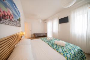 a bedroom with a large bed and a window at La Dimora del Sole in Monopoli