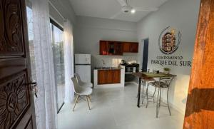 a kitchen with a table and chairs in a room at Apartamento minimalista con balcón in Fernando de la Mora +9 photos