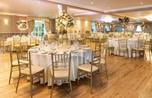 a banquet hall with white tables and chairs at Woodford Dolmen Hotel Carlow in Carlow