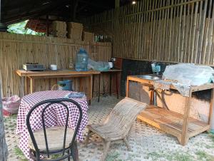 a patio with a table and a table and chairs at Banana garden in Pai