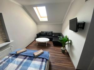 a living room with a couch and a table at Pokoje na wynajem w Willi in Warsaw