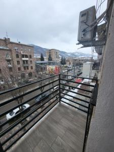 a balcony with a tv on the side of a building at Rayana's in Vanadzor