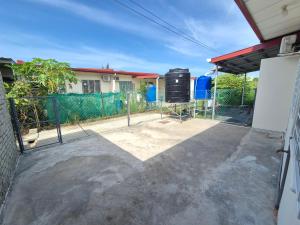 a fence in front of a house at Lim'S Homestay Kudat in Kudat