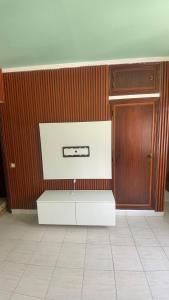 a room with a white cabinet and a wooden door at Kamana Studio in Luanda