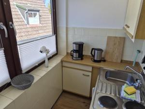 a small kitchen with a sink and a window at Ostseeliebe 5 in Dahme +4 photos