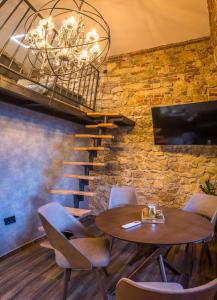 a dining room with a table and chairs and a staircase at Sky Apartman 2 in Kučevo