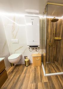 a bathroom with a toilet and a shower at Sky Apartman 2 in Kučevo