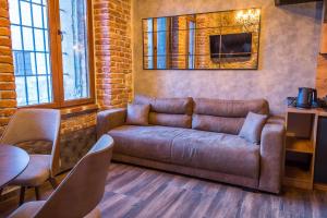 a living room with a couch and a table at Sky Apartman 2 in Kučevo