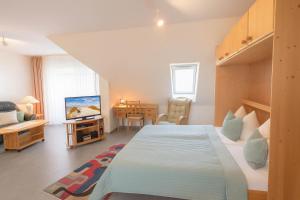 a bedroom with a large bed and a desk at Boje 15 in Schillig