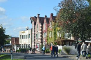 a group of people walking down a street with buildings at Boje 15 in Schillig