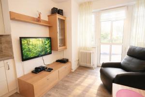a living room with a couch and a flat screen tv at Boje 5 in Schillig