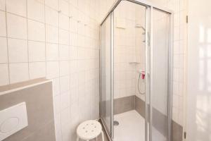 a bathroom with a shower with a toilet at Boje 5 in Schillig +15 photos