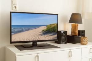 a flat screen tv sitting on top of a dresser at Boje 7 in Schillig