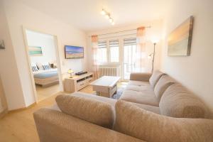 a living room with a couch and a bedroom at Boje 9 in Schillig