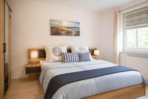 a bedroom with a large bed and a window at Boje 9 in Schillig