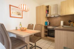 a small kitchen with a table and chairs in a room at Boje 9 in Schillig