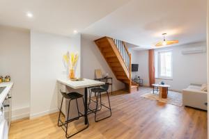 a kitchen and living room with a table and chairs at Lavagnou Duplex in La Ciotat