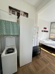 a room with a desk and a bed in a room at Studio avec vue sur le Château in Azay-le-Rideau