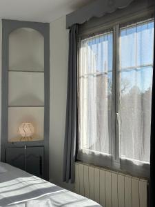 a bedroom with a bed and a window at Studio avec vue sur le Château in Azay-le-Rideau