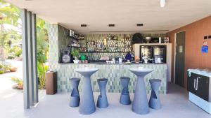 a bar with blue vases in front of a counter at Terreforti Boutique Spa & Glamping in Agrigento