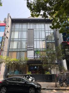 a black car parked in front of a building at FarGo Hotels By Lowfare Hotels in Bangalore