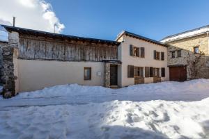 a building with a lot of snow in front of it at L’Écrin des Neiges - Proche Station de Ski in Formiguères