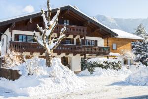 a house covered in snow in front of it at Beim Bretzner - Chiemgau Karte in Inzell