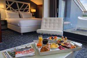 a tray of food on a table in a hotel room at Hôtel de Brienne in Toulouse