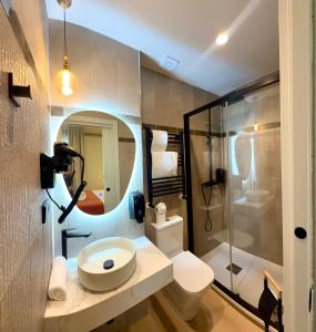 a bathroom with a sink and a toilet and a shower at Hostal Sol Square Madrid in Madrid +52 photos